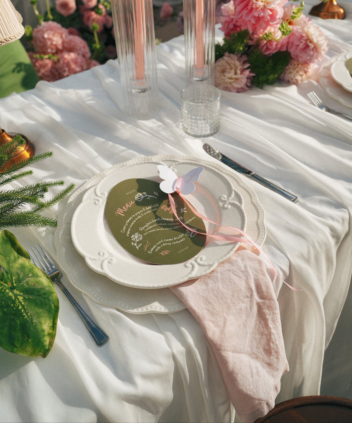Wedding table setting with custom menu card tied with pink ribbon at Austinvilla Estate